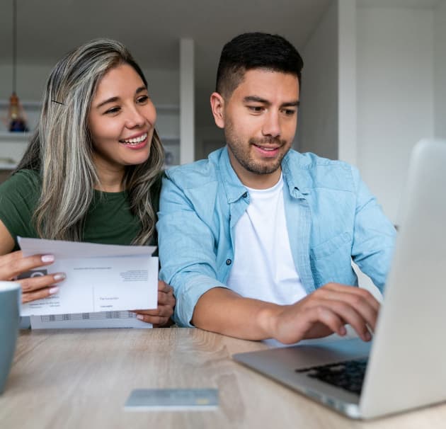 Happy customers working with laptop at home